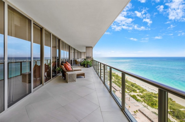 balcony with a water view and a beach view