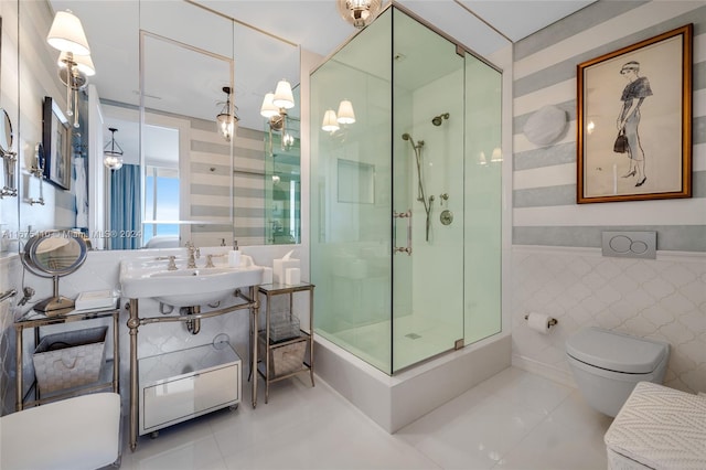 bathroom featuring tile walls, toilet, a shower with shower door, sink, and tile patterned floors