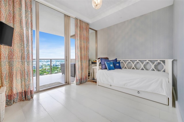 bedroom featuring a wall of windows and access to exterior