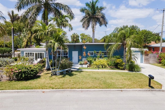 view of front facade with a front yard and a garage