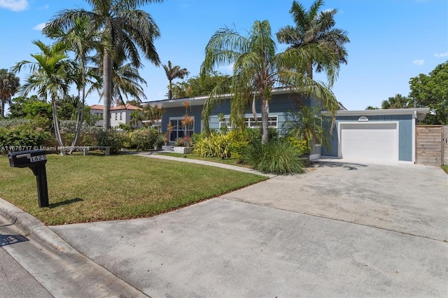 view of front of property with a garage and a front lawn