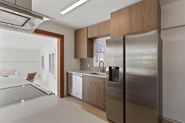 kitchen featuring decorative backsplash, appliances with stainless steel finishes, and sink