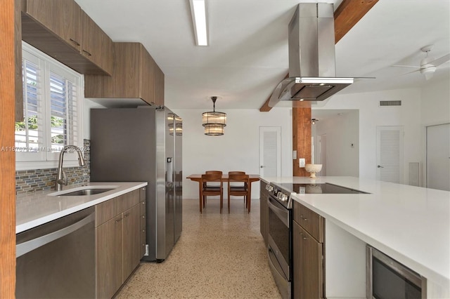 kitchen featuring ceiling fan, sink, ventilation hood, decorative light fixtures, and appliances with stainless steel finishes