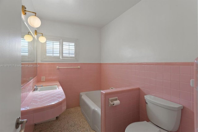 bathroom with a bathtub, toilet, and tile walls