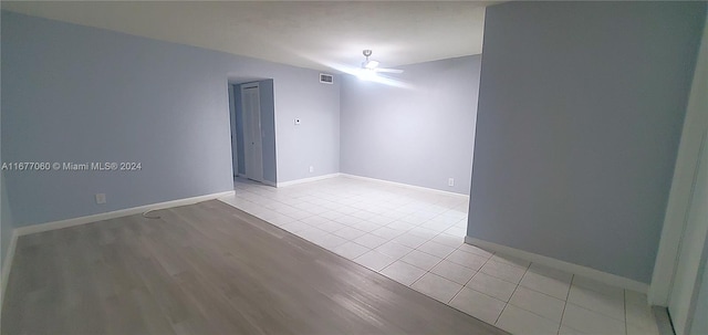 spare room featuring light hardwood / wood-style floors and ceiling fan