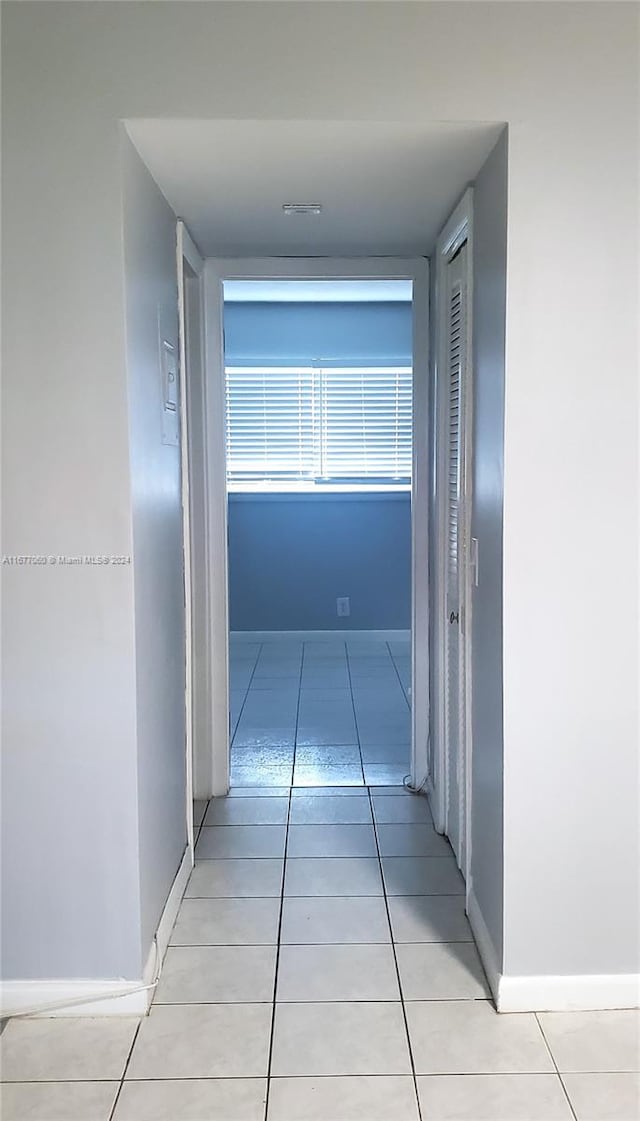 corridor featuring light tile patterned flooring