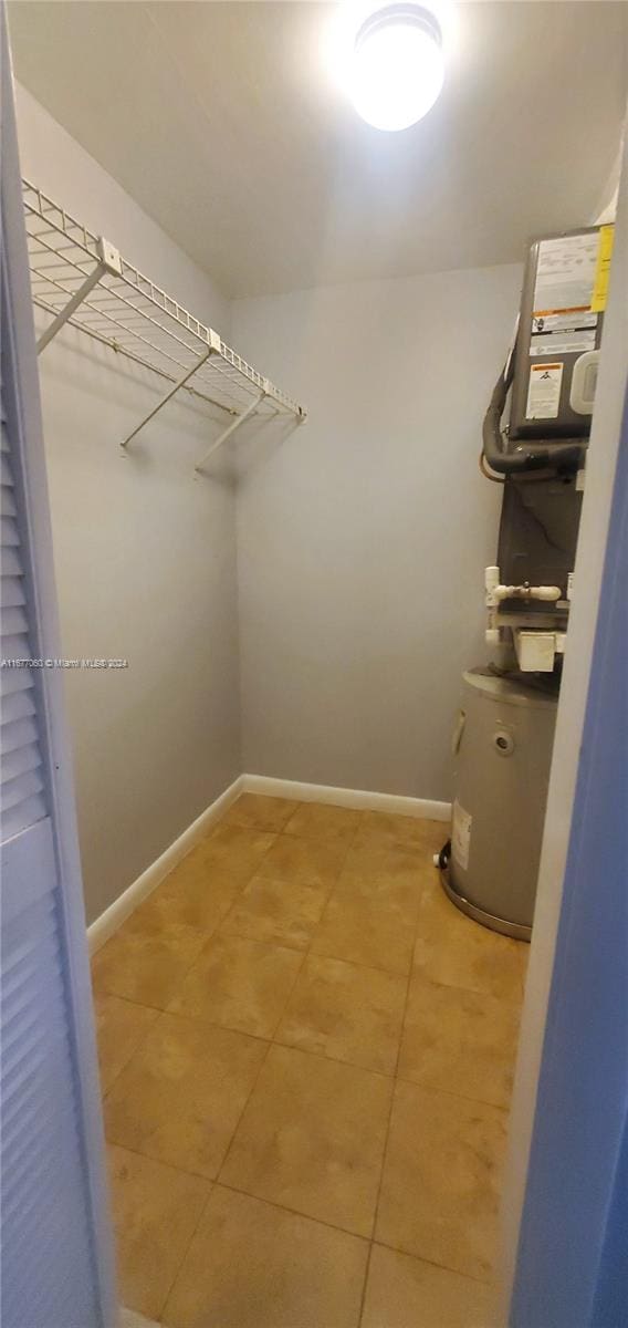 walk in closet with tile patterned flooring