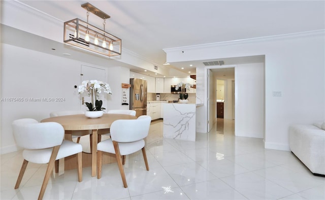 tiled dining area featuring ornamental molding