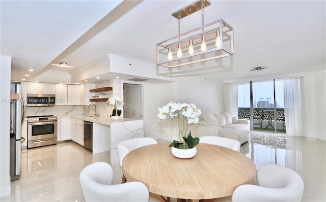 dining area featuring ornamental molding and sink