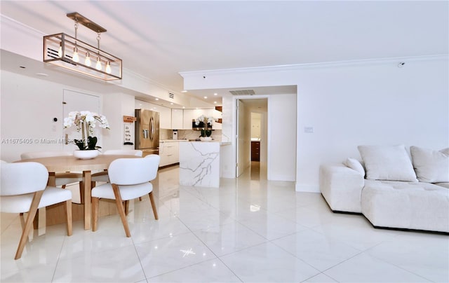 tiled dining area featuring ornamental molding