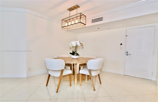 dining area with ornamental molding and light tile patterned floors