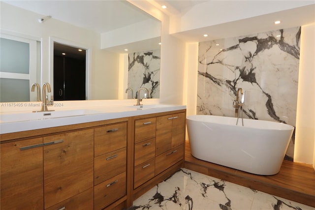 bathroom featuring vanity, a bathing tub, and tile walls