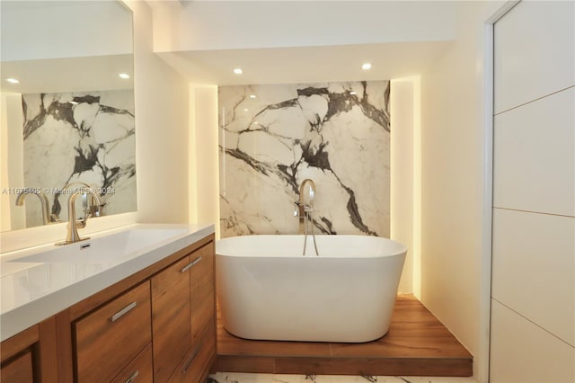 bathroom featuring vanity and a bath