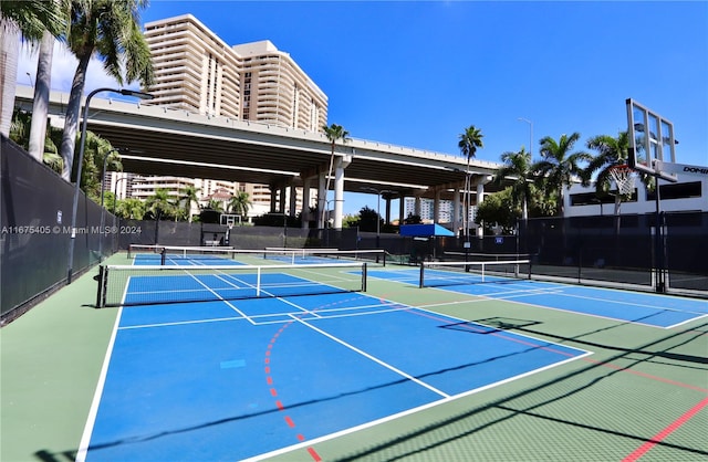 view of tennis court featuring basketball hoop