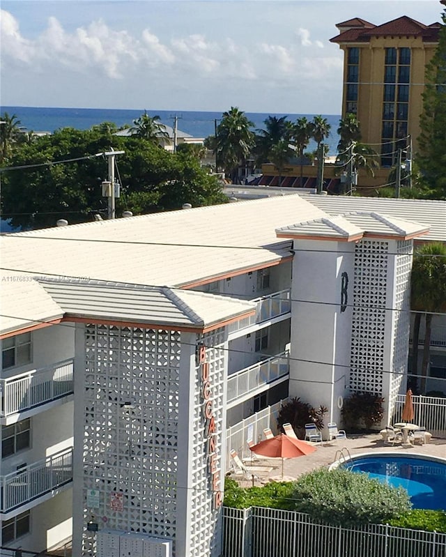 exterior space with a water view and a community pool