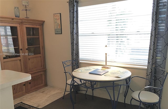 dining space with tile patterned floors