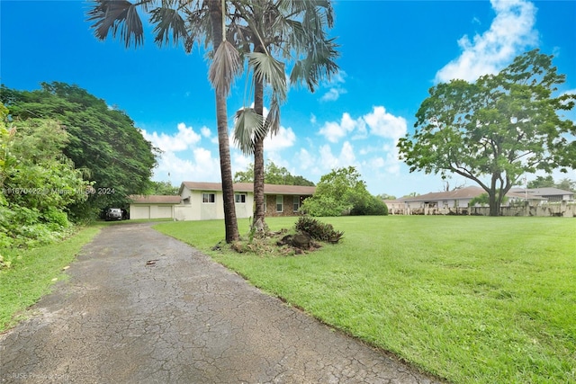 ranch-style home featuring a front yard