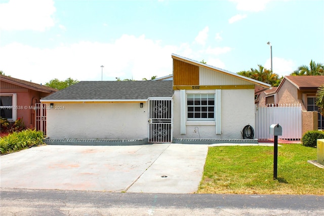 ranch-style house with a front lawn