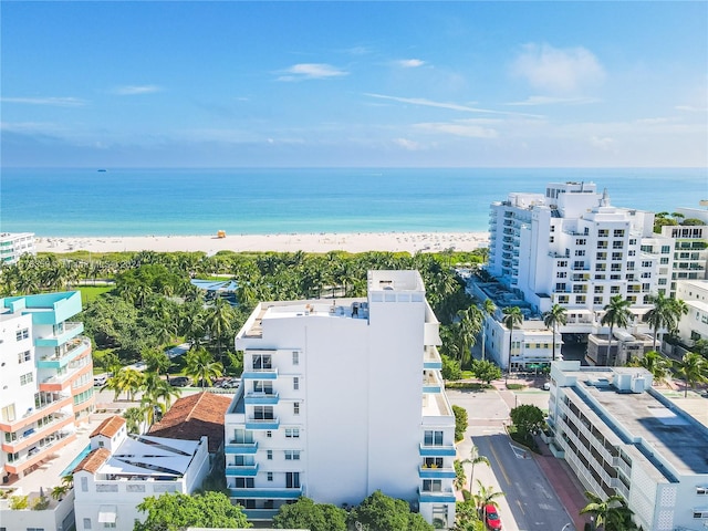 birds eye view of property with a view of the beach and a water view