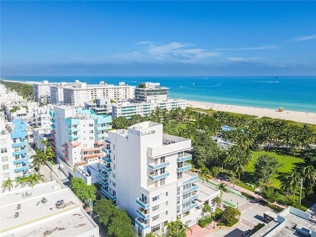 bird's eye view featuring a water view and a beach view