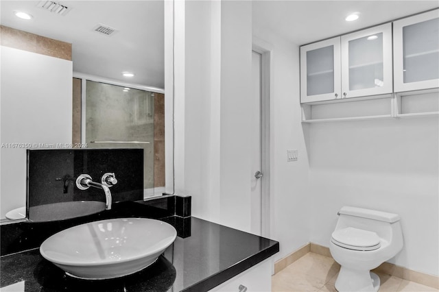 bathroom with vanity, toilet, and tile patterned floors