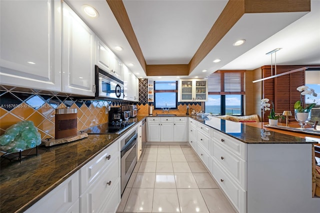 kitchen featuring decorative backsplash, white cabinetry, sink, and appliances with stainless steel finishes