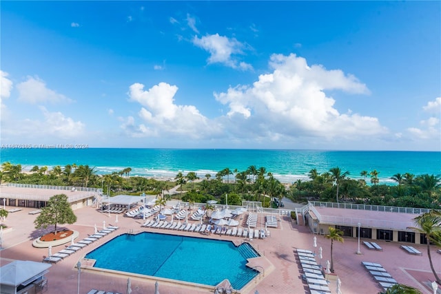 view of pool featuring a water view