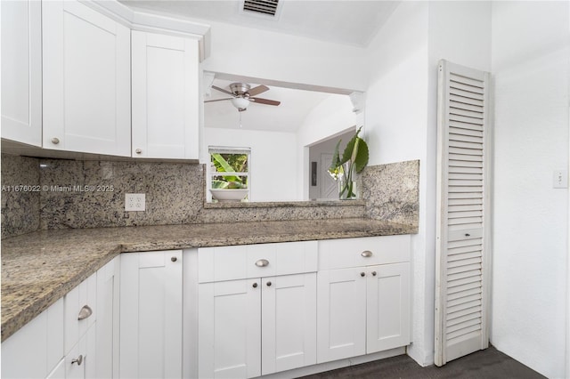 kitchen featuring tasteful backsplash, visible vents, white cabinets, ceiling fan, and light stone counters