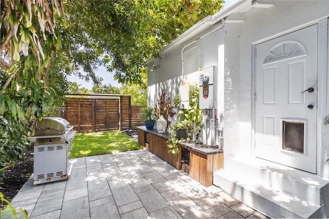 view of patio featuring area for grilling and fence