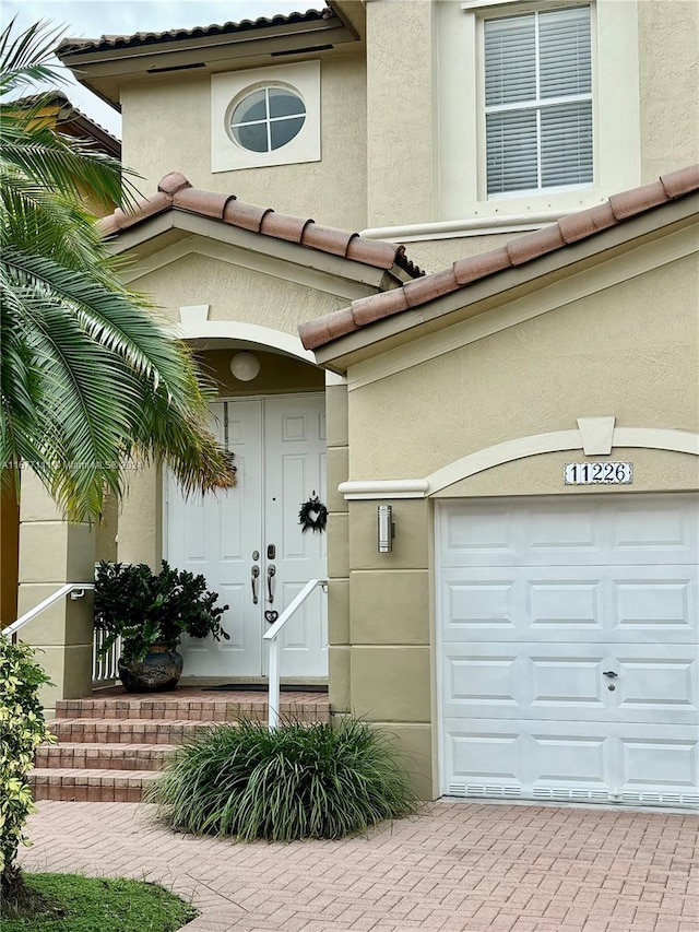 doorway to property with a garage