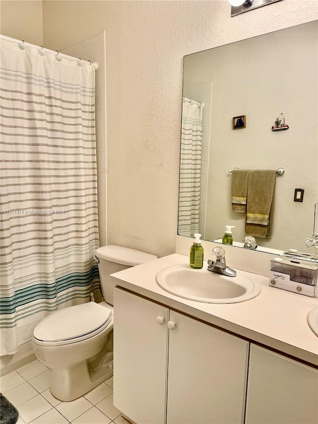 bathroom with vanity, toilet, tile patterned floors, and curtained shower