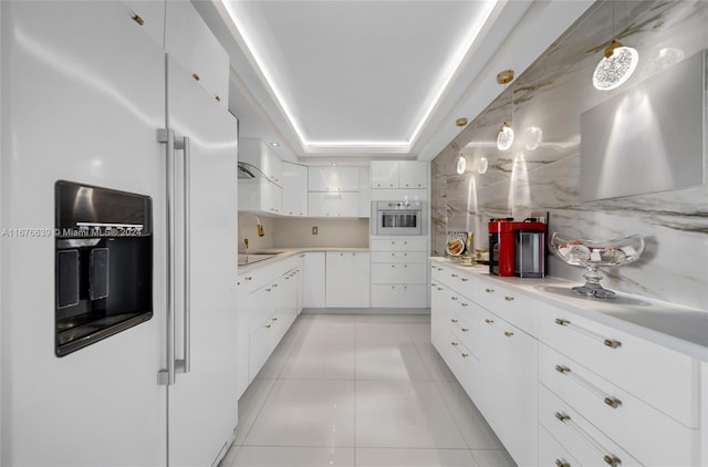 kitchen featuring oven, white cabinets, hanging light fixtures, light tile patterned floors, and white fridge with ice dispenser