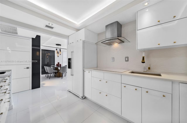 kitchen featuring wall chimney range hood, white fridge with ice dispenser, white cabinetry, electric stovetop, and light tile patterned flooring