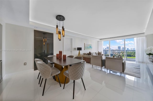 tiled dining area featuring a notable chandelier and floor to ceiling windows