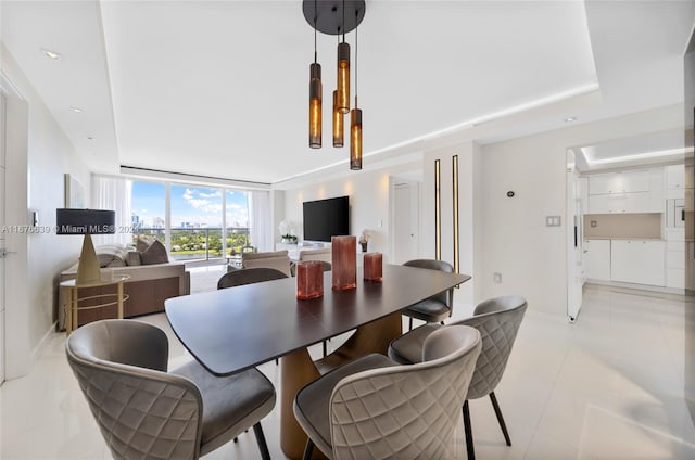 dining room featuring light tile patterned floors and floor to ceiling windows