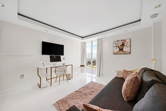 tiled living room featuring a raised ceiling