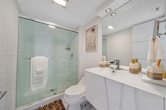 bathroom with vanity, an enclosed shower, and toilet