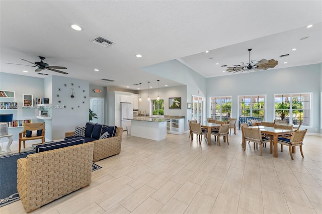 dining area with ceiling fan and a textured ceiling