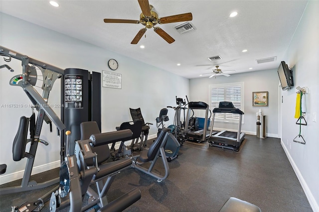 exercise area with a textured ceiling and ceiling fan