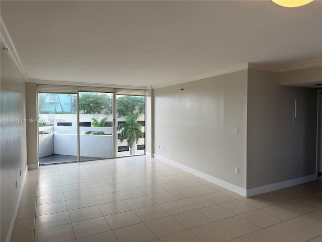 spare room with light tile patterned floors and ornamental molding