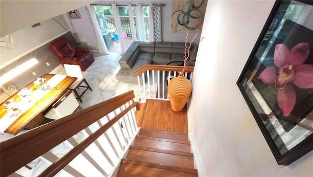 stairs featuring hardwood / wood-style floors