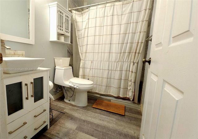 bathroom featuring toilet, hardwood / wood-style flooring, and vanity