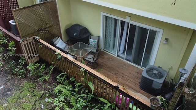 wooden deck featuring central air condition unit