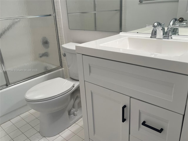 full bathroom with tile patterned floors, vanity, toilet, and shower / bath combination with glass door