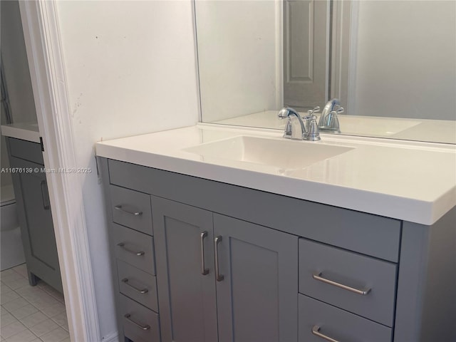 bathroom with tile patterned floors, vanity, and toilet