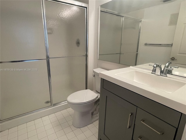 bathroom featuring tile patterned floors, a shower with door, vanity, and toilet