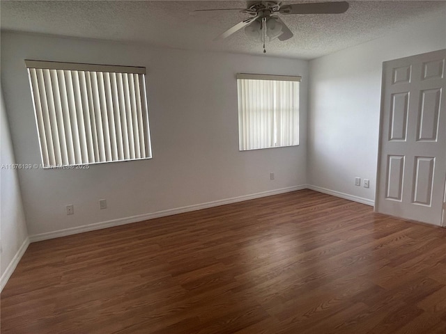 empty room featuring a textured ceiling, dark hardwood / wood-style floors, and ceiling fan