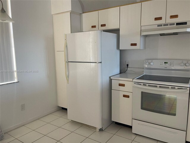 kitchen with white cabinets, light tile patterned floors, and white appliances