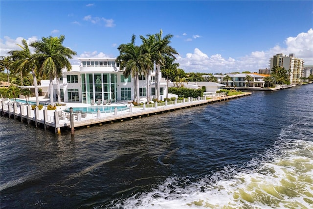 exterior space with a community pool and a water view