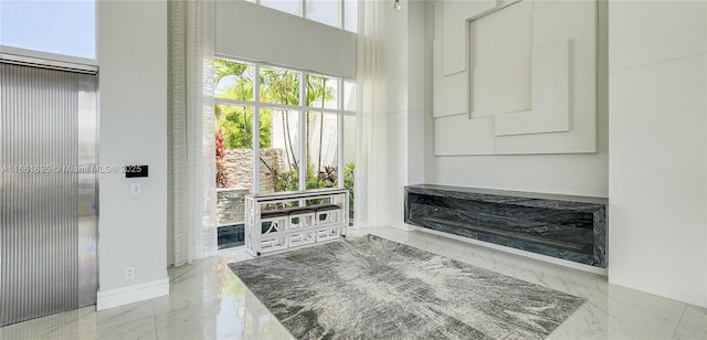 interior space featuring a wealth of natural light and a towering ceiling